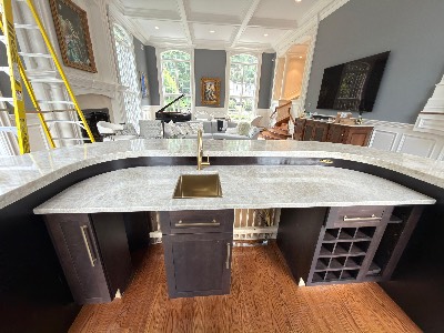 Custom island with marble top and wine rack by CJ Woodwork LLC