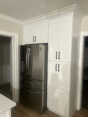 Built-in pantry cabinets and fridge surround by CJ Woodwork LLC