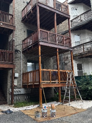 Staining rear porches with drop cloths laid below