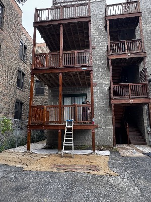 Stained rear porches on a brick condo building