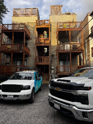 Lara's Power Wash trucks below newly stained rear porches