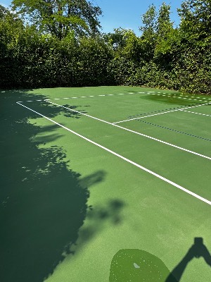 Freshly washed green tennis court