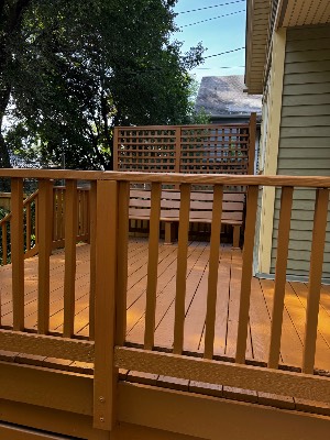 Stained deck railing in warm cedar tone