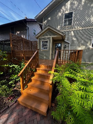 Newly stained front stairs and railing