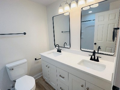 Renovated bathroom with double vanity and black fixtures