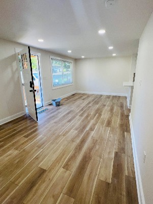 Open living space with new flooring and fresh paint