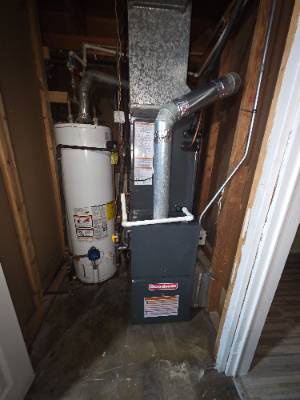 Furnace and gas water heater installed together in a utility closet