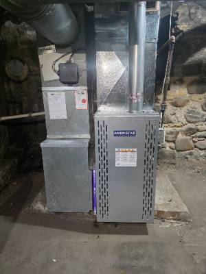 Furnace and sheet metal plenum installed in a stone-walled basement