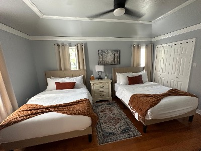 Guest bedroom with two freshly made beds