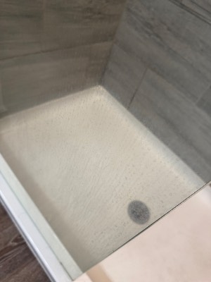 Spotless white shower base and drain