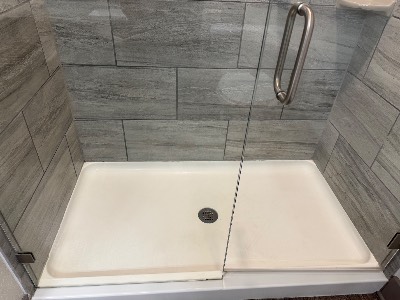 Clean tiled shower with glass door