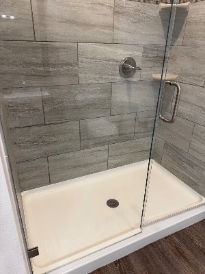 Clean tiled shower with glass door