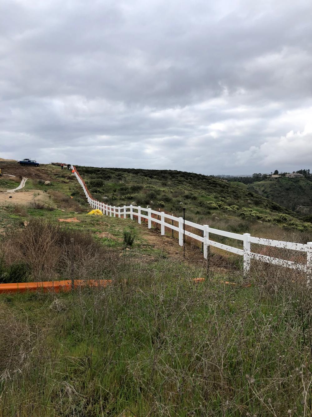 Building a Fence on a Slope: Stepped vs. Racked Panels