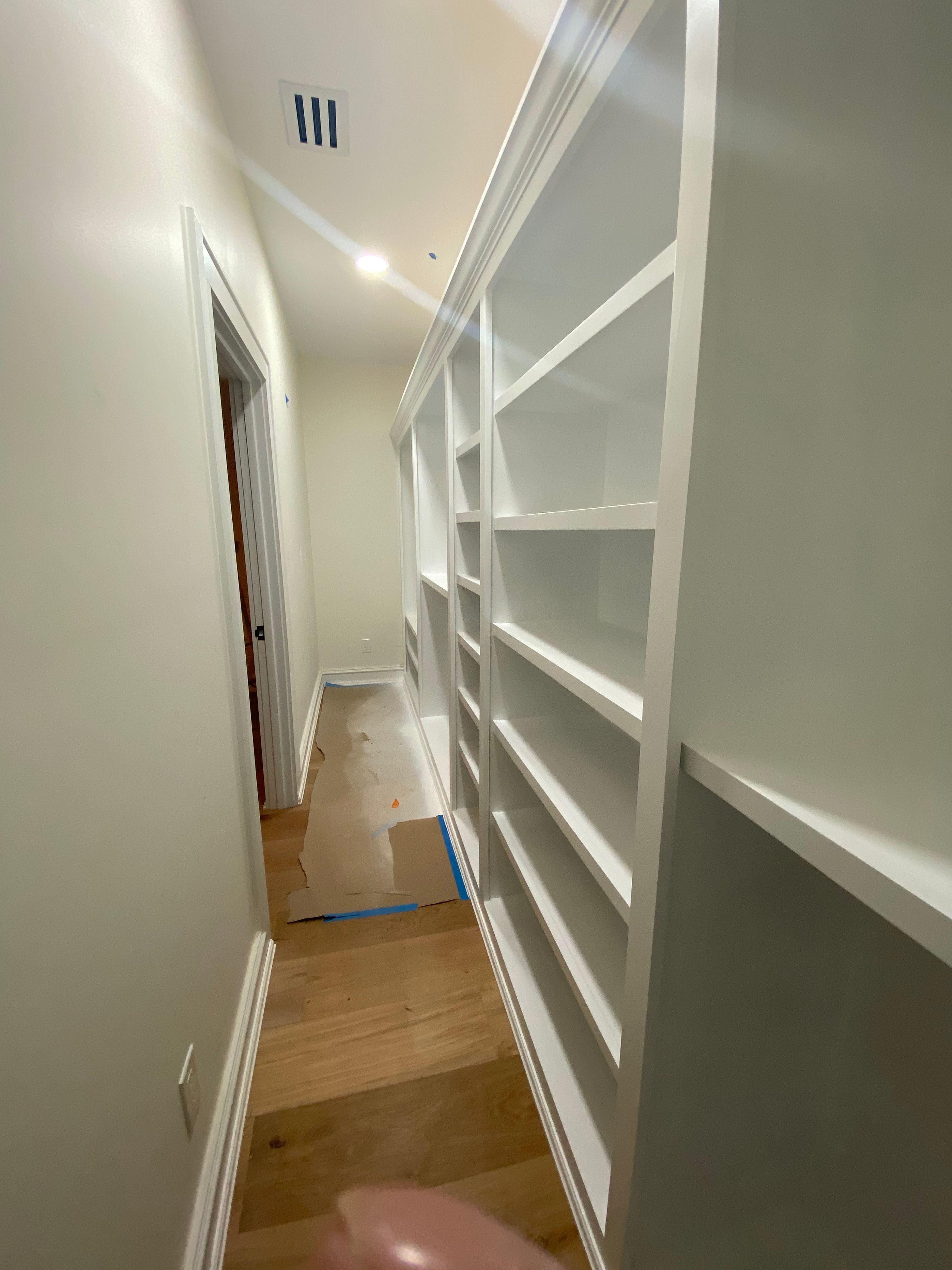 A hallway of built-in shelving finished by Jireh Painting and Remodeling