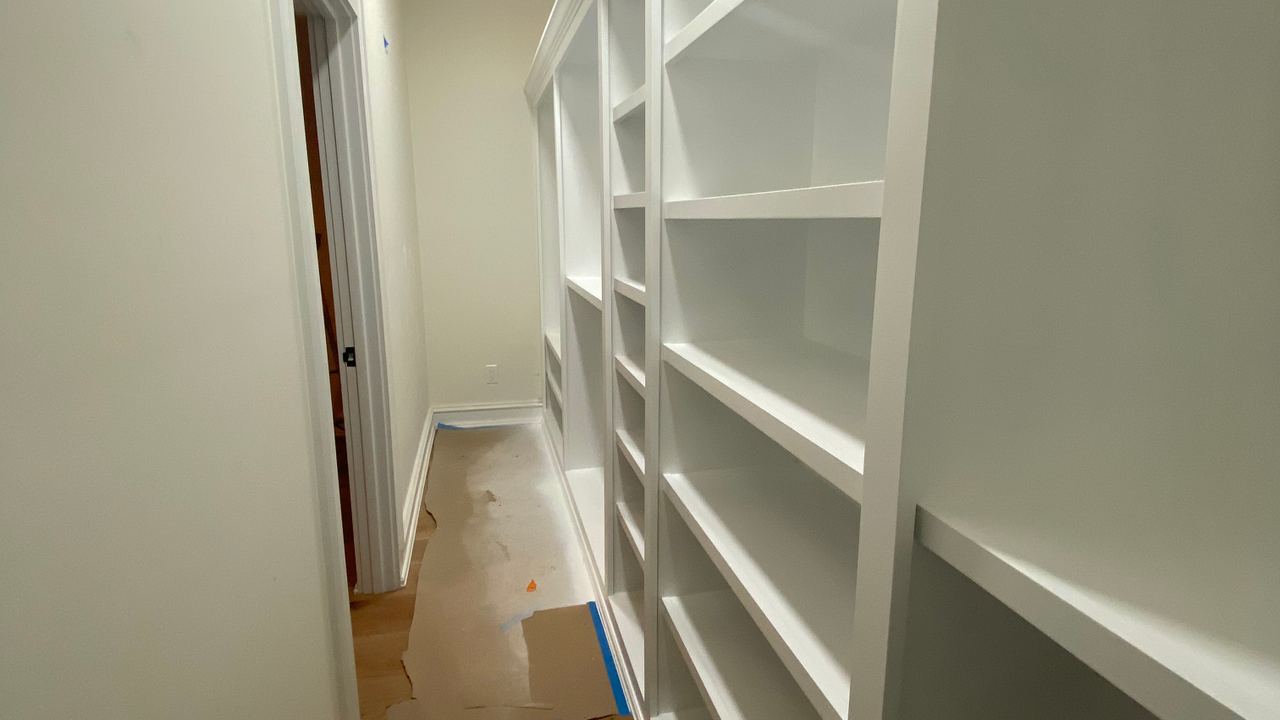 A hallway of built-in shelving finished by Jireh Painting and Remodeling