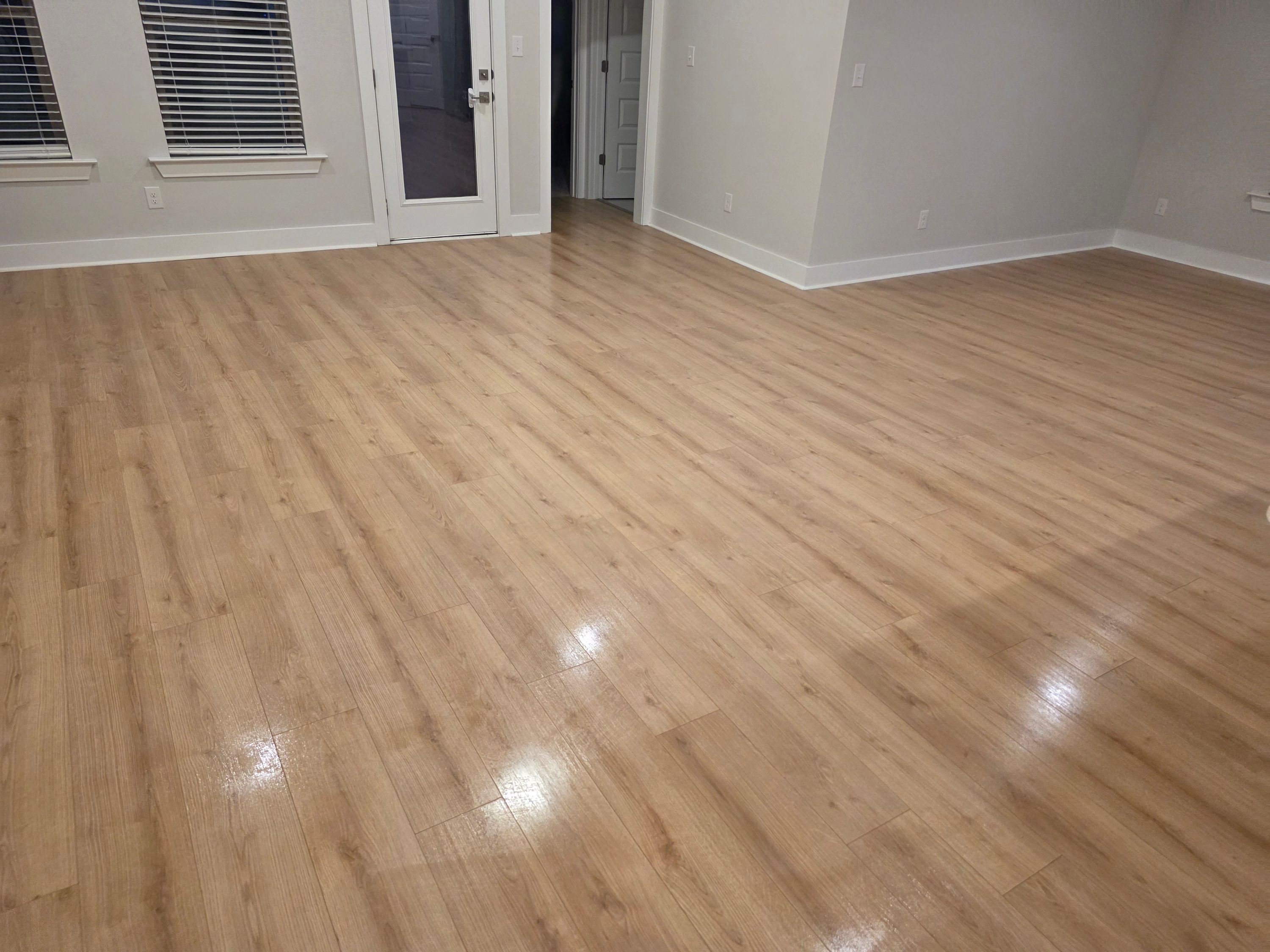 Freshly cleaned living room with polished hardwood floors by Sandra House Cleaning Service in Huntsville, AL