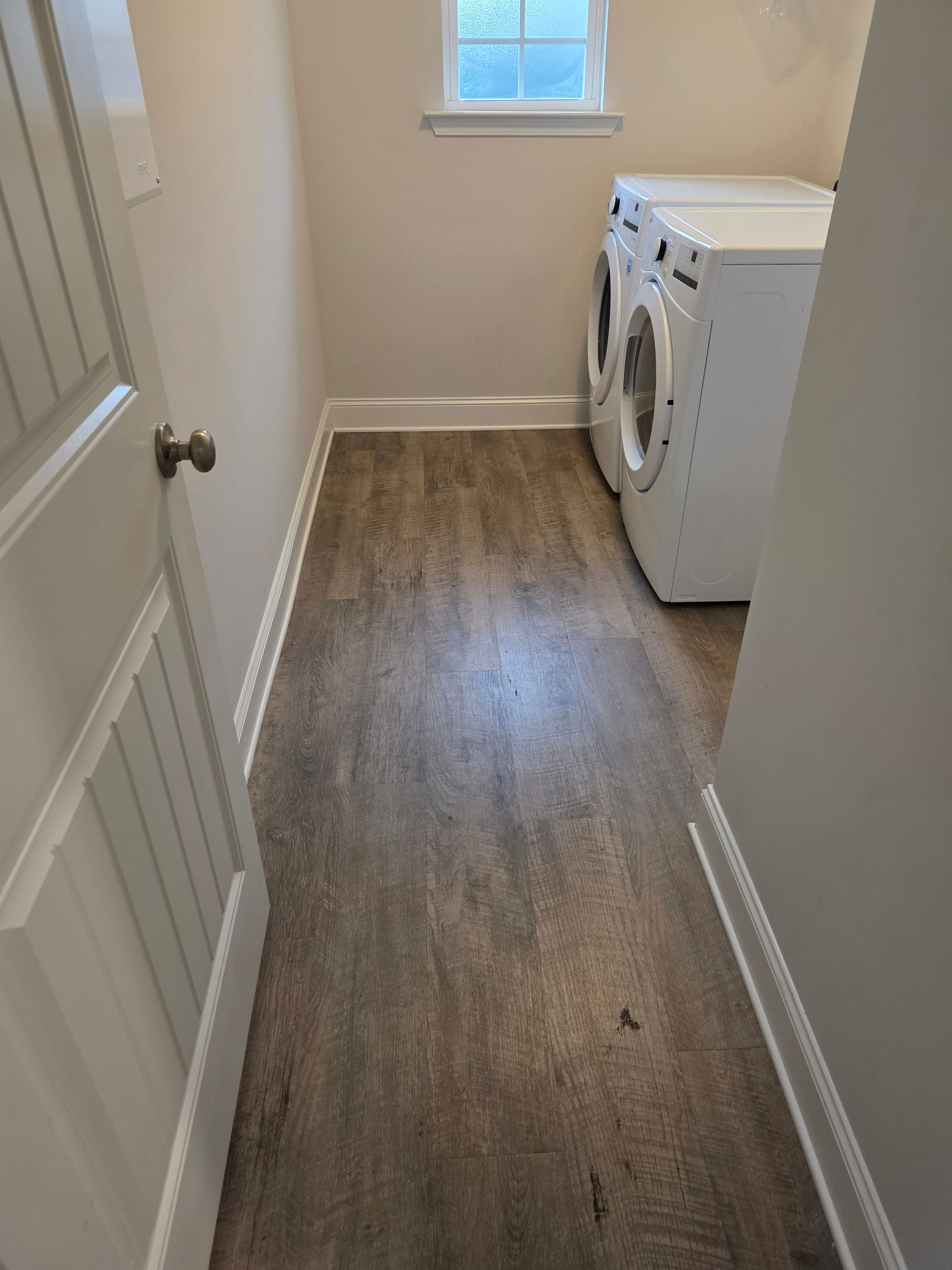 Spotless laundry room and vinyl plank floor cleaned by Sandra House Cleaning Service in Huntsville, AL