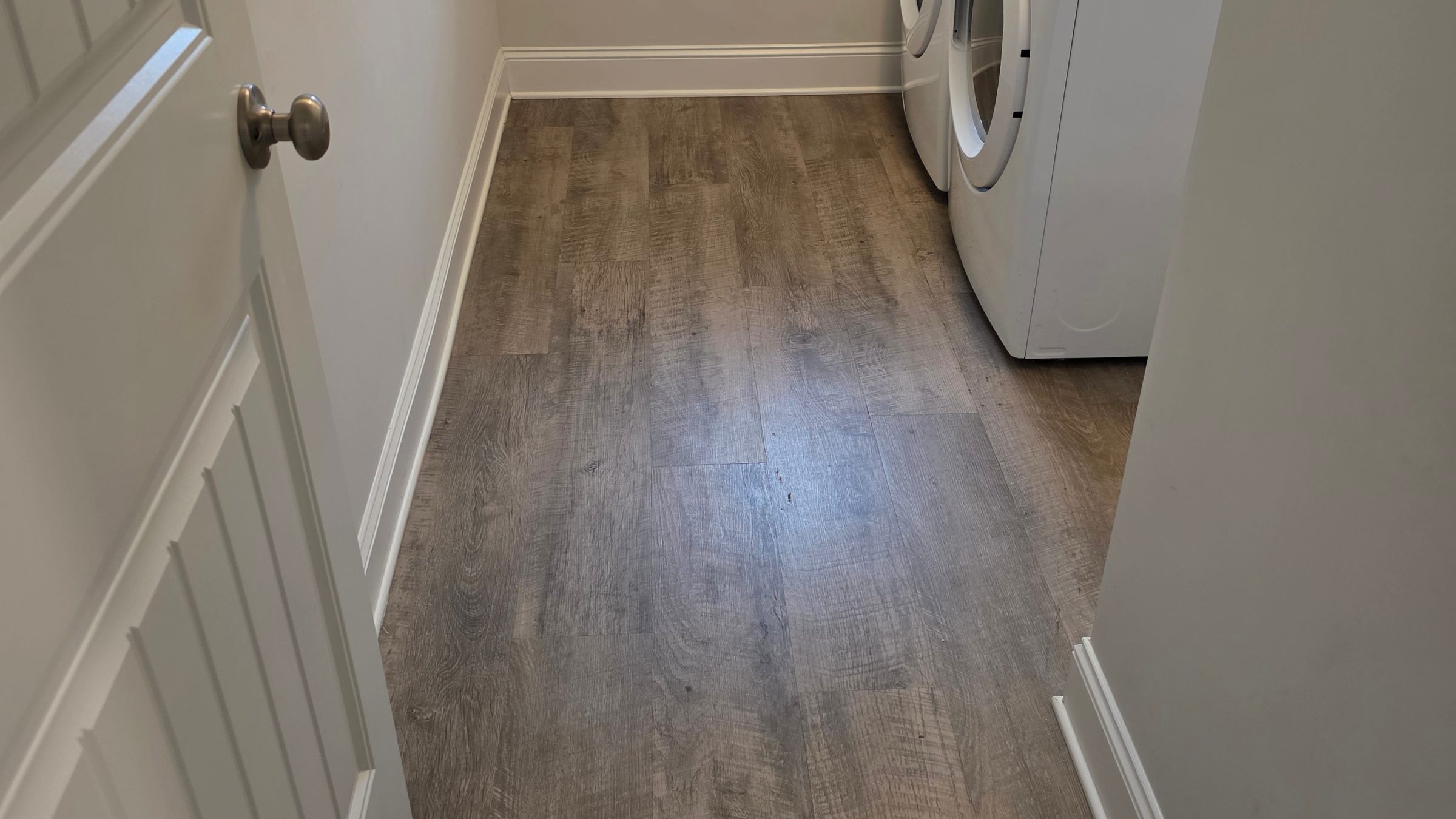 Spotless laundry room and vinyl plank floor cleaned by Sandra House Cleaning Service in Huntsville, AL