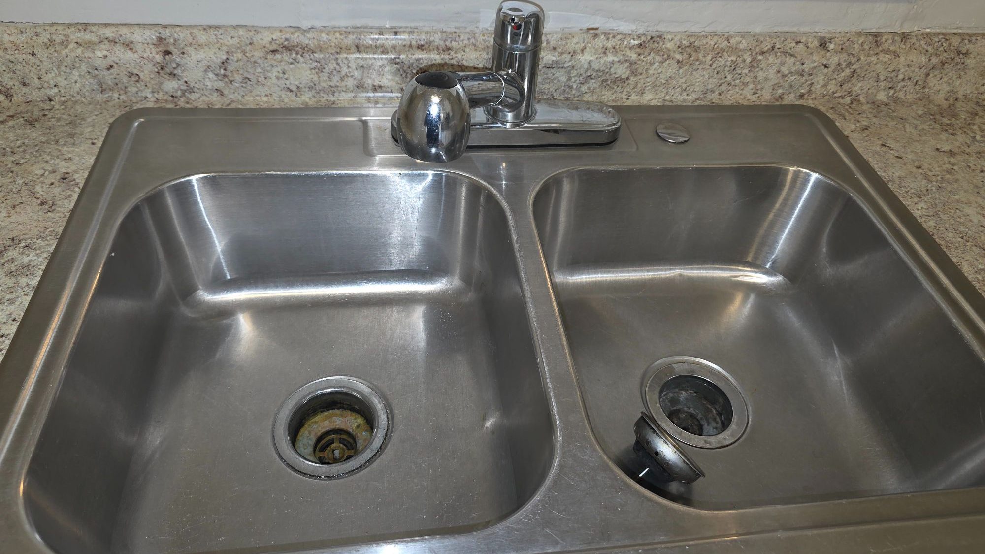 Polished stainless steel kitchen sink cleaned by Sandra House Cleaning Service in Huntsville, AL
