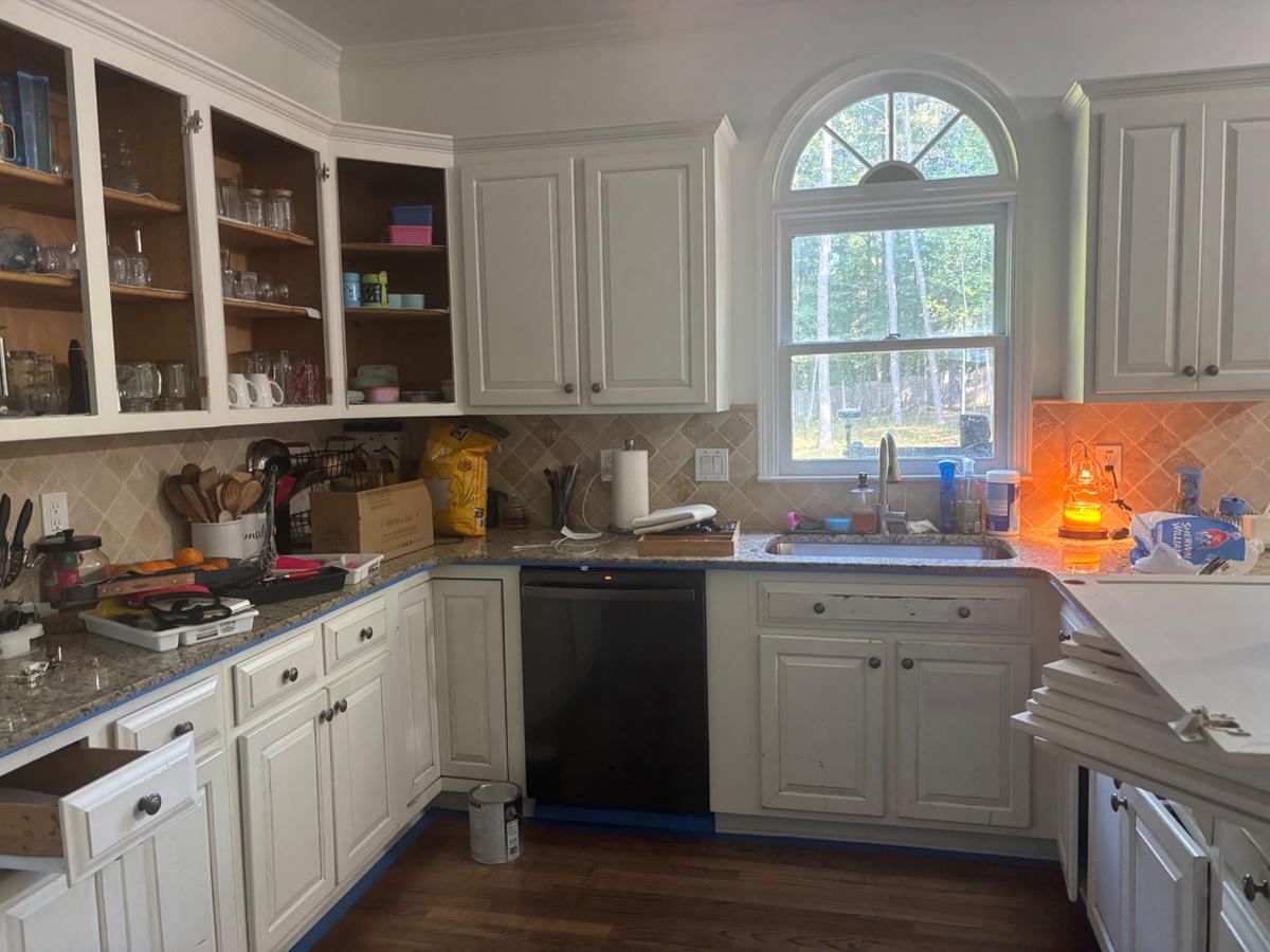 Kitchen cabinet repaint in navy and white — before