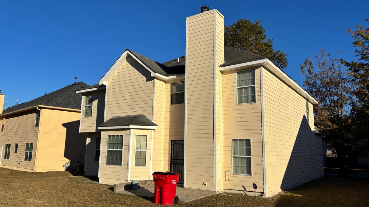 Freshly painted siding and trim on a two-story home finished by ABC Renovations