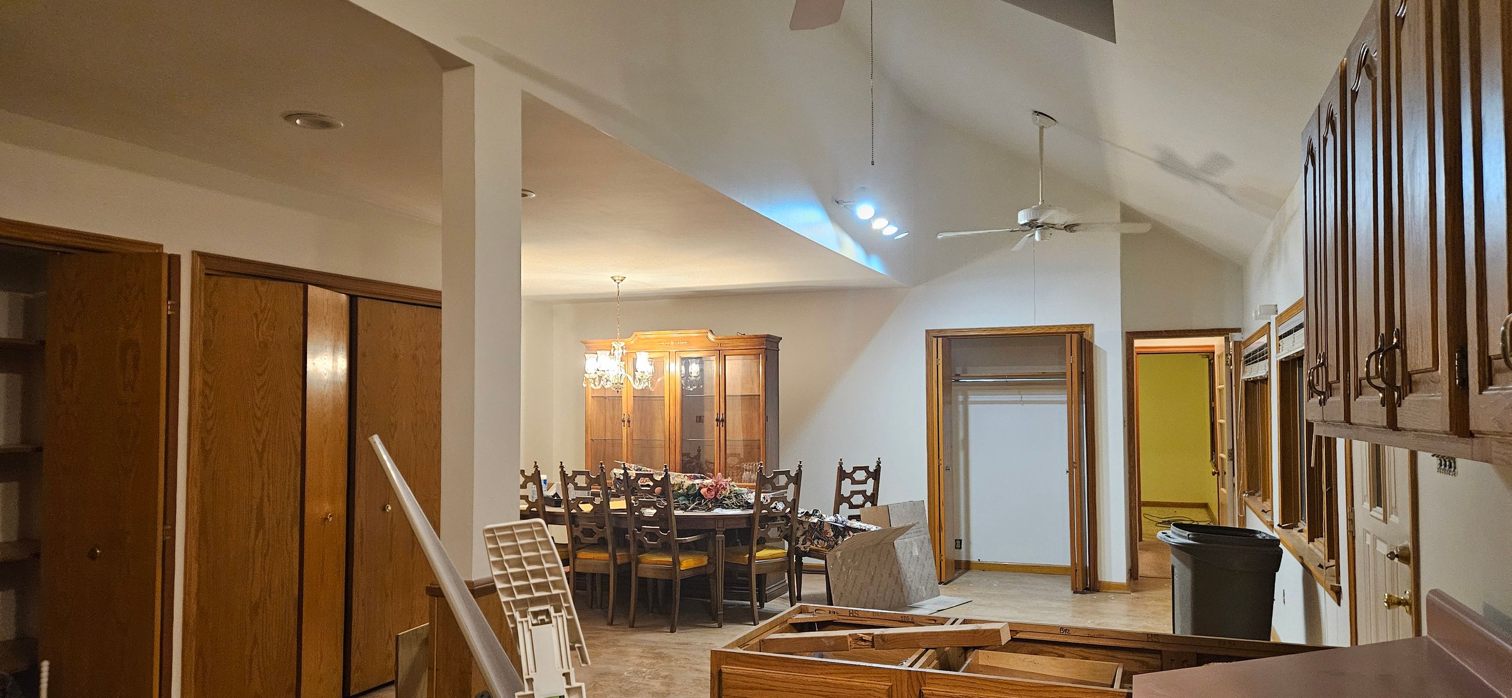 Open vaulted great room and dining area with white walls freshly rolled, tools still out