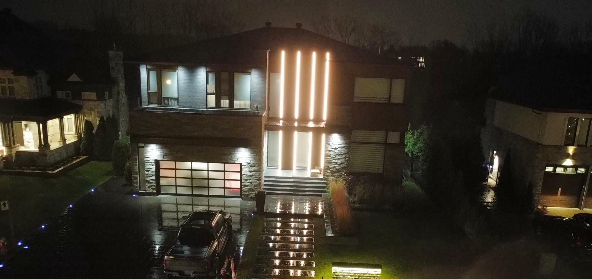 Modern home exterior with architectural facade lighting, a Caztelan Group project