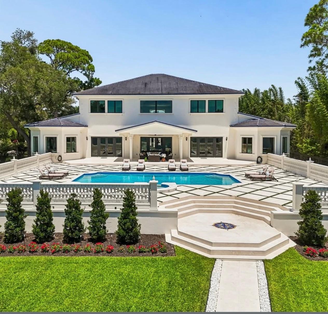 Travertine pool deck and hand-set compass medallion installed by Christo & Pedroni Tile