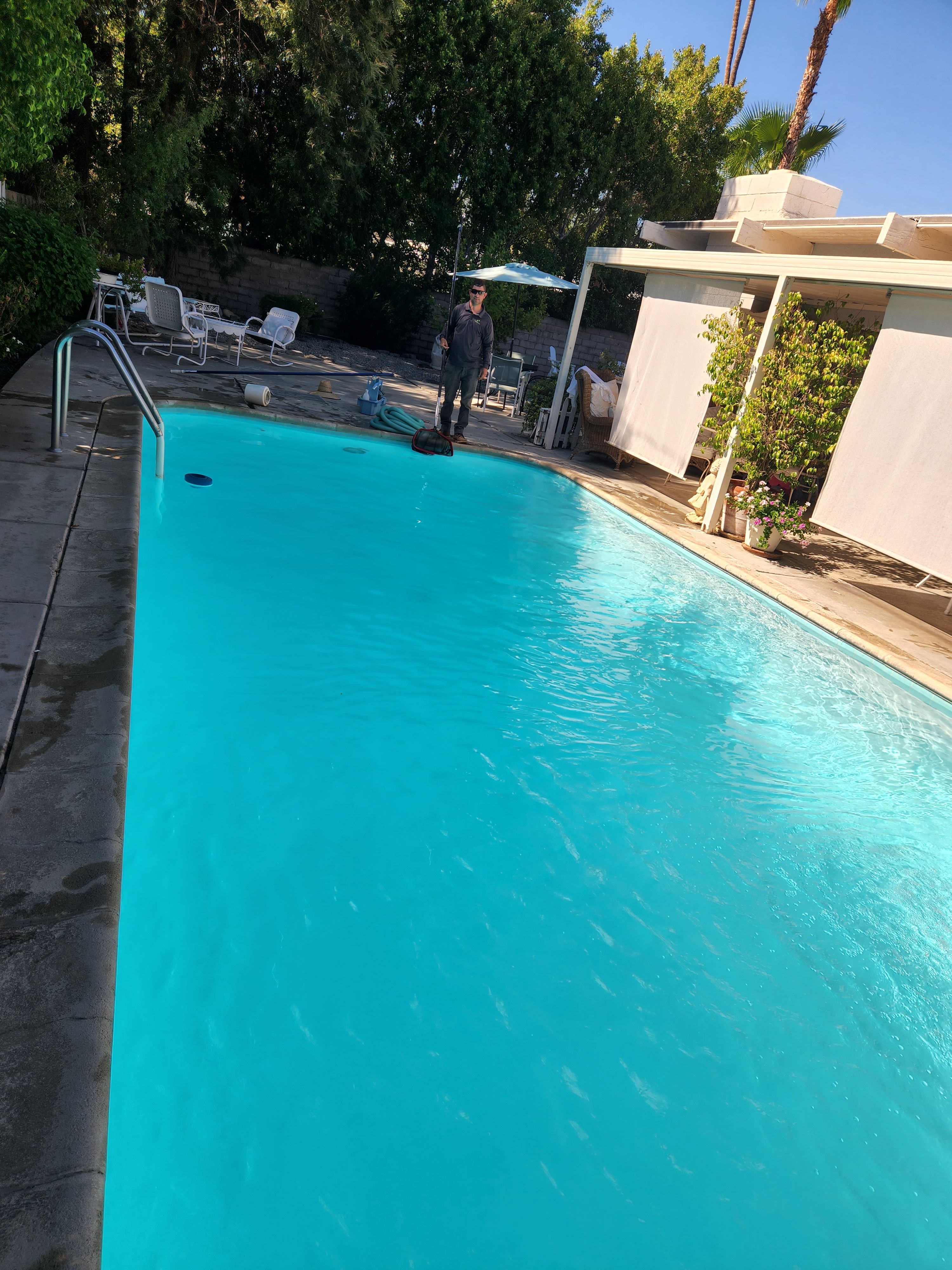 Clear blue backyard pool and patio maintained by Clear Waters Pool Service in Cathedral City, CA