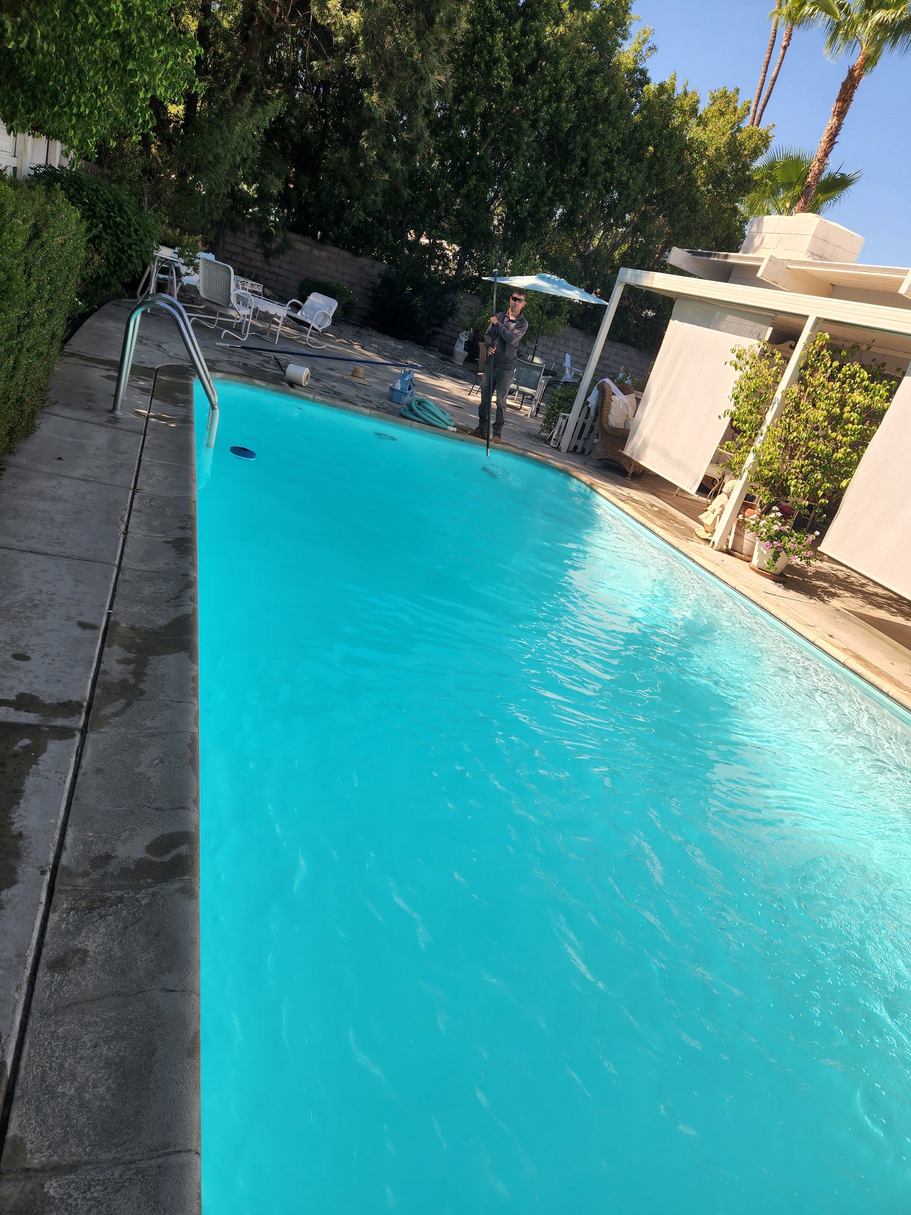 Bright turquoise residential pool cleaned by Clear Waters Pool Service in the Coachella Valley, California