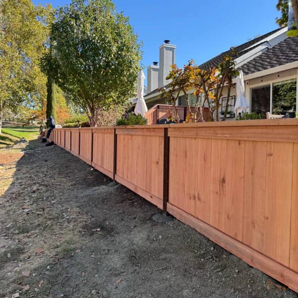New redwood privacy fence along a backyard