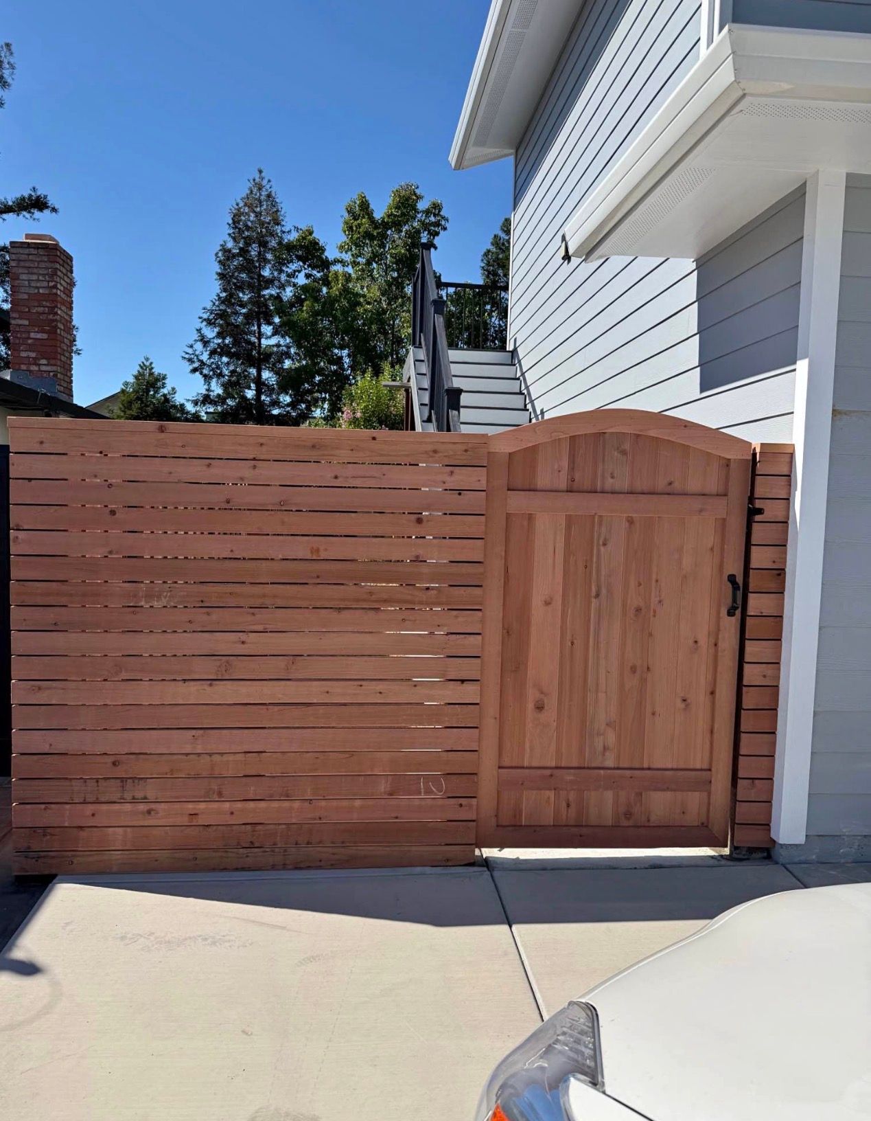 Horizontal slat redwood fence with a matching gate