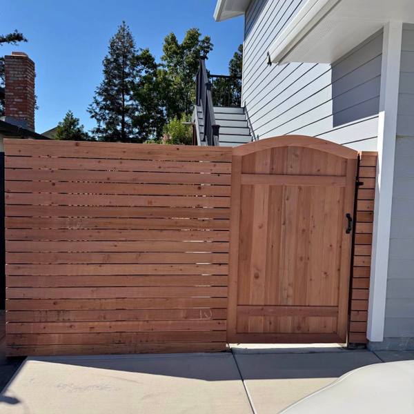 Horizontal slat redwood fence with a matching gate
