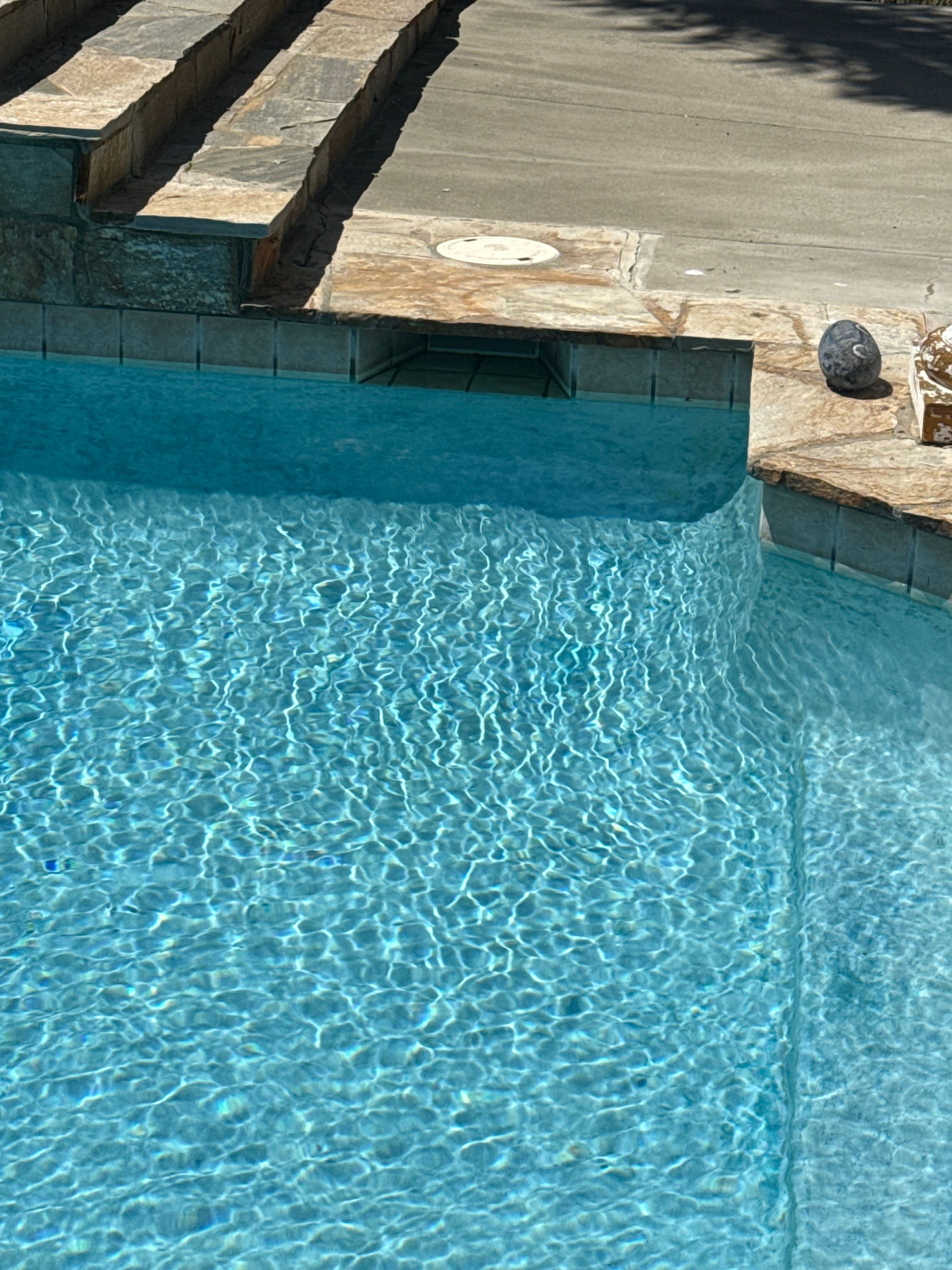 Sparkling clear swimming pool water after a service visit
