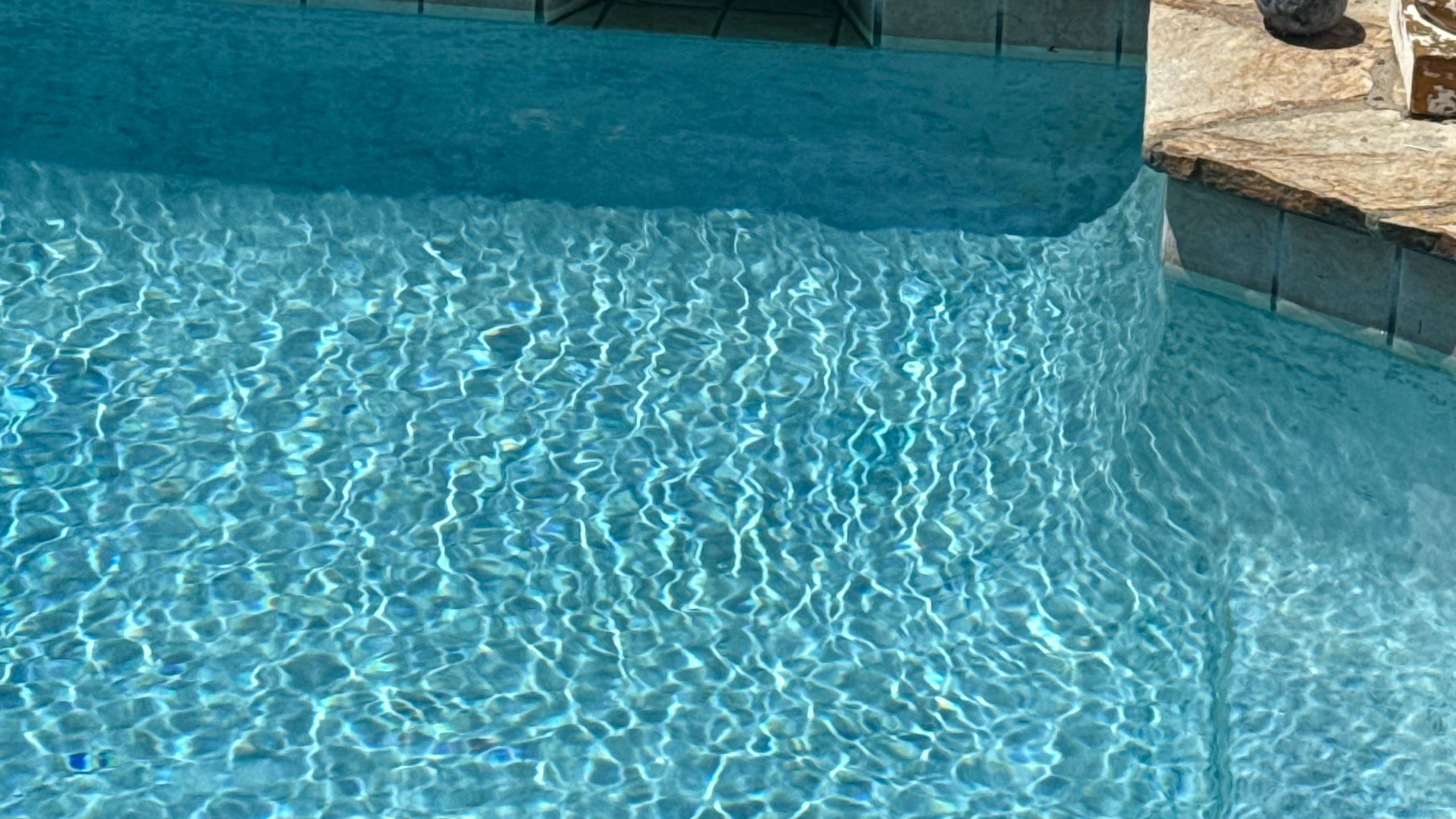 Sparkling clear swimming pool water after a service visit
