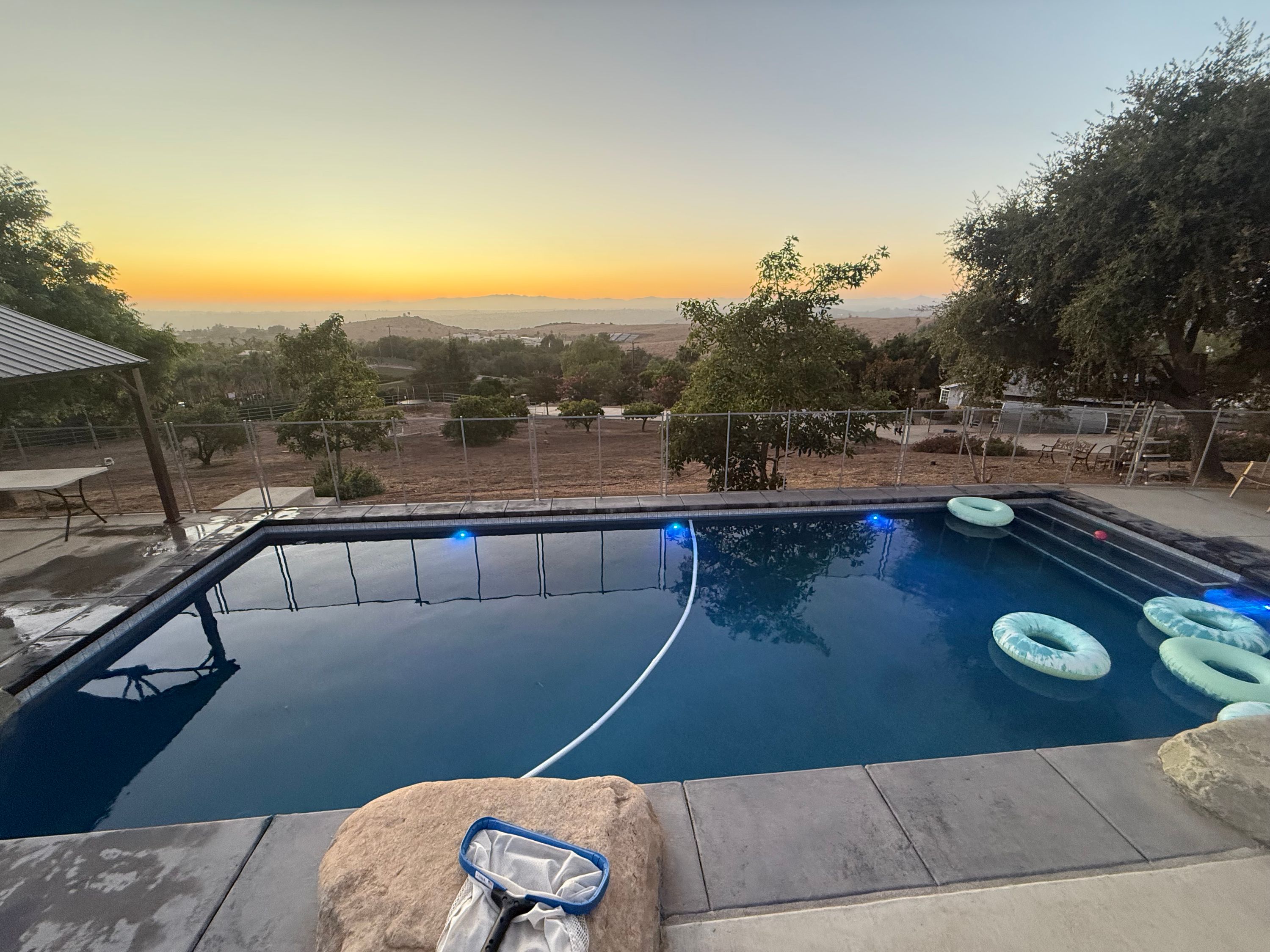 Clean backyard swimming pool at sunset in Fallbrook, California