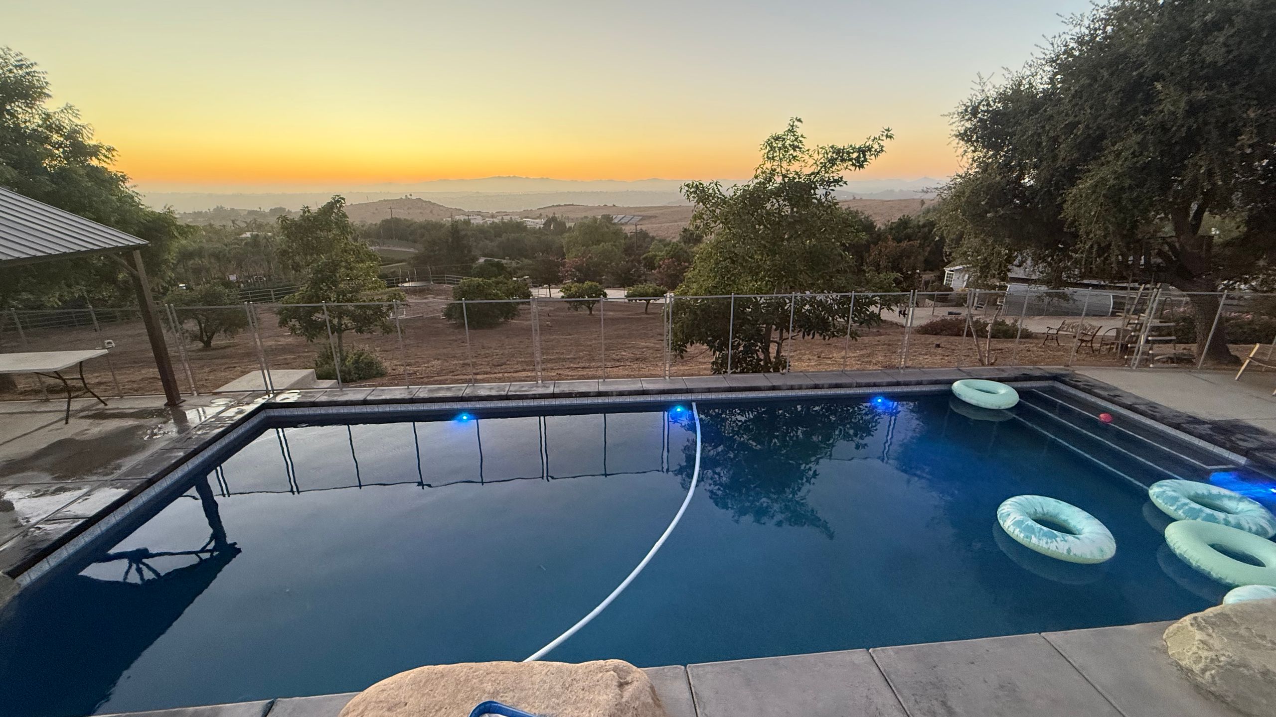 Clean backyard swimming pool at sunset in Fallbrook, California