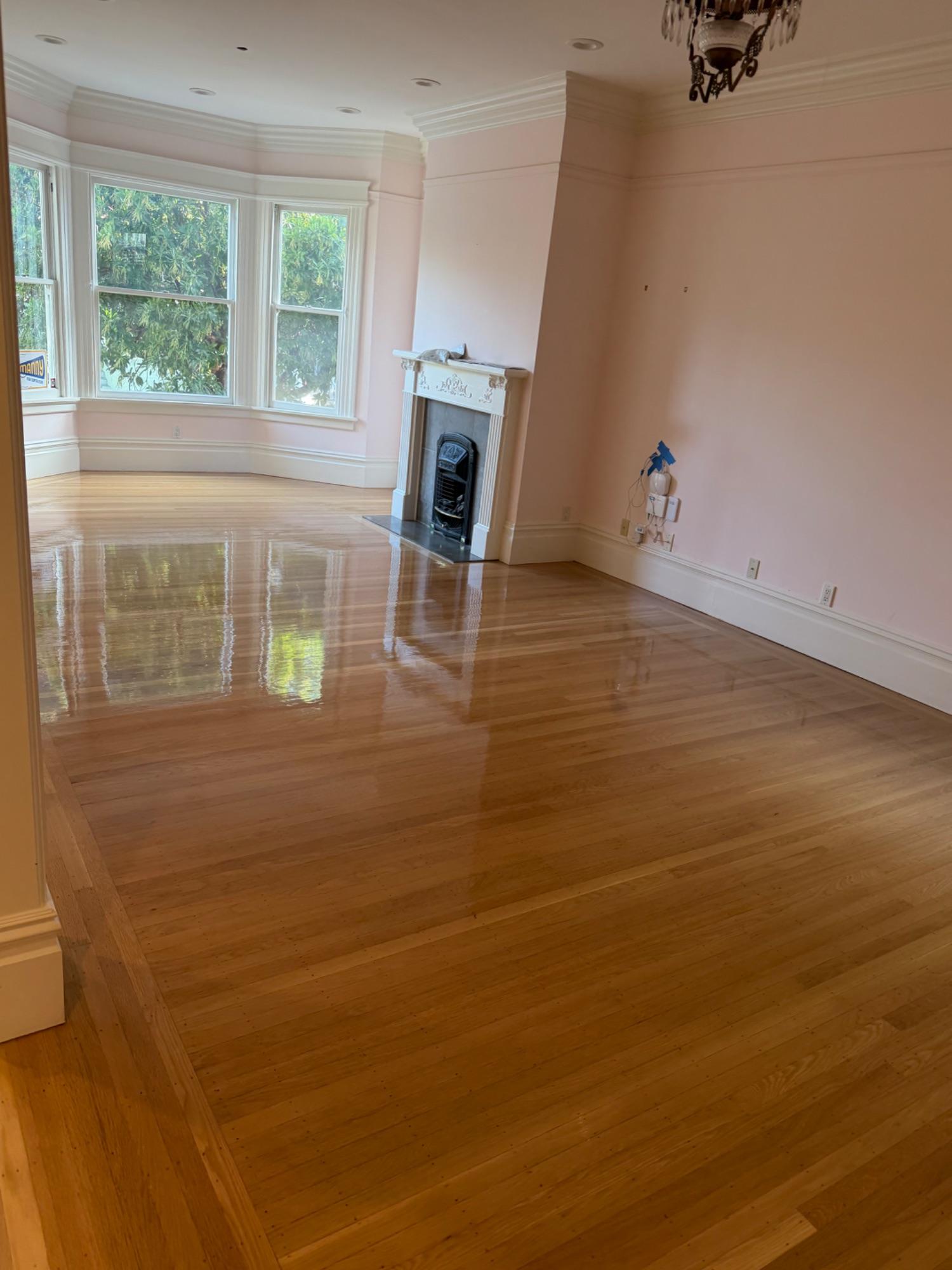 Refinished hardwood floor with a high-gloss finish in a San Francisco living room