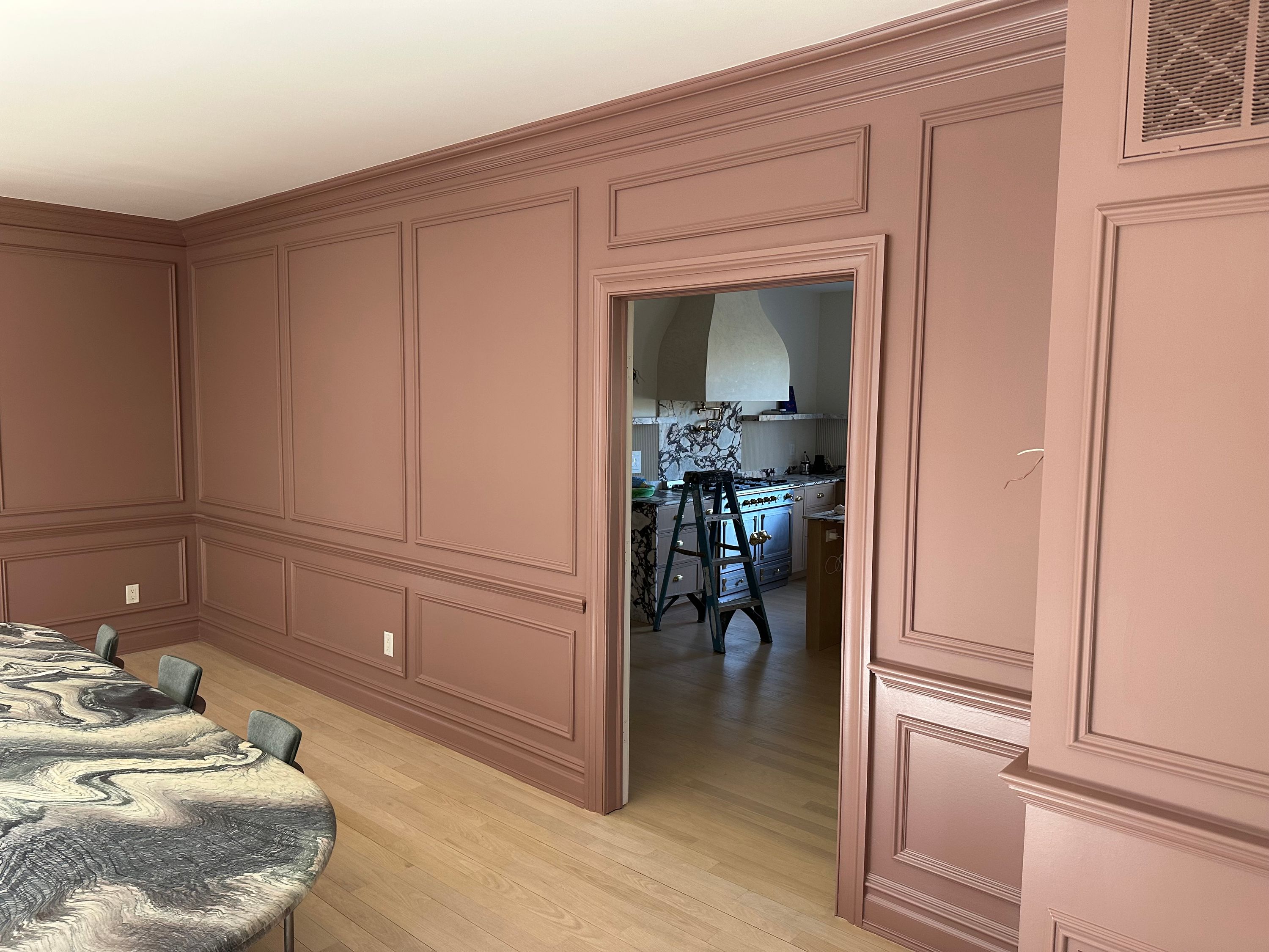 Dusty pink dining room and doorway, showing the finished wainscoting and trim work — FE Pro Painting