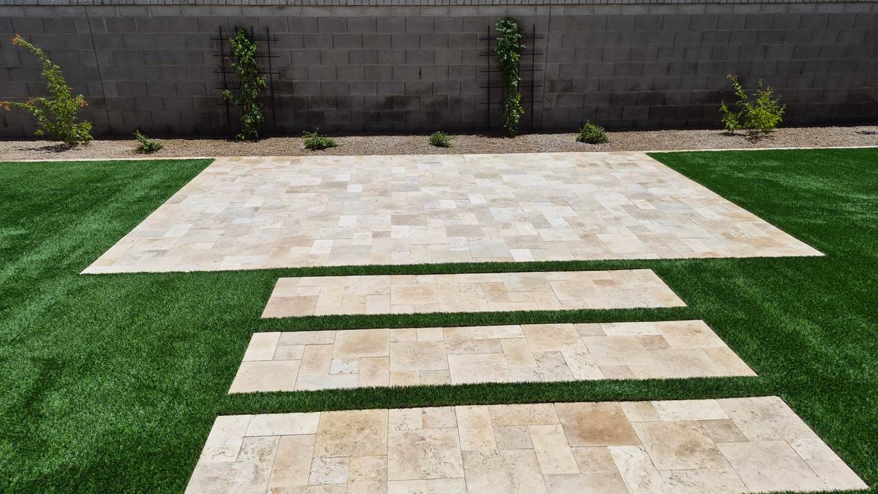 Travertine patio and synthetic grass backyard built by German LLC in Phoenix, AZ