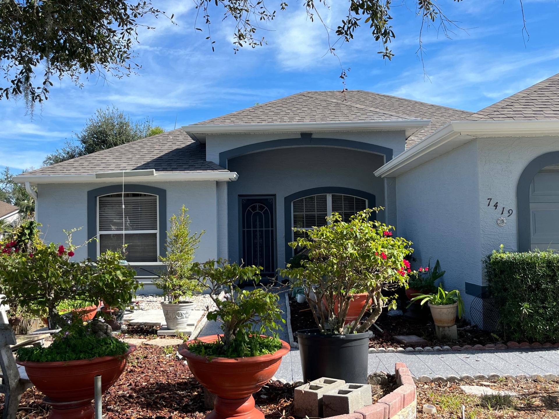 Front of a Bradenton home freshly repainted in blue-grey with white trim by GLD Painting Professional