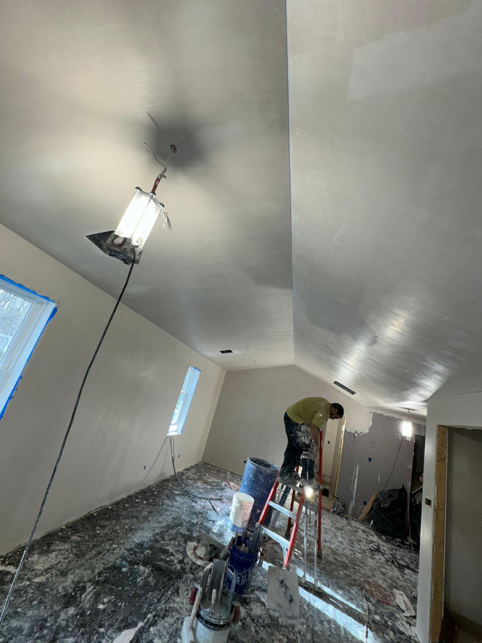 Henrique Plastering crew finishing a vaulted plaster ceiling