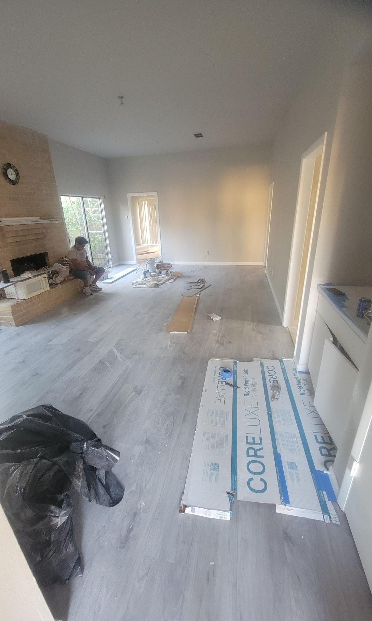 Living room with new vinyl plank flooring being installed by A to Z Remodeling