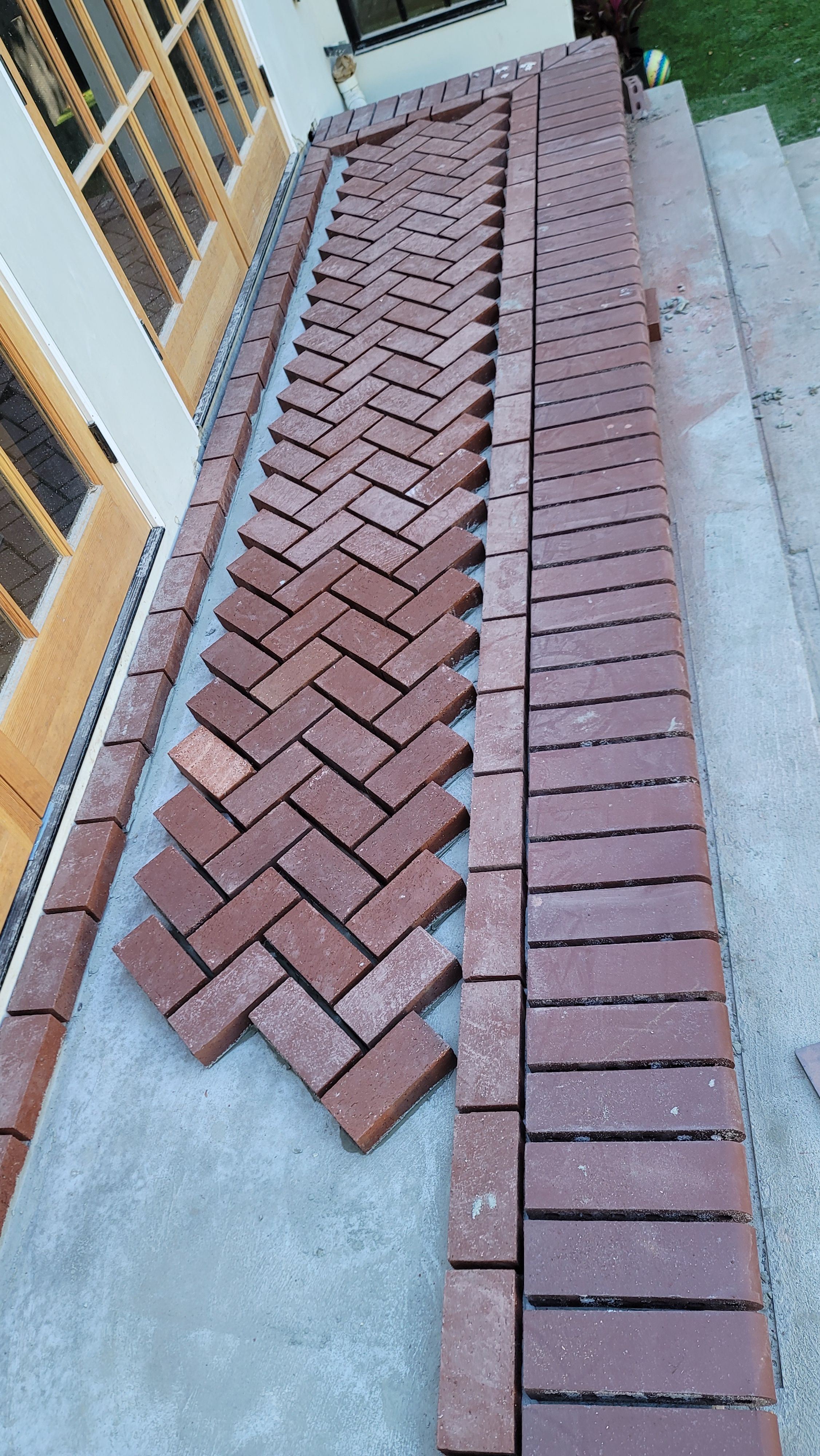 Herringbone brick paving with a soldier-course border