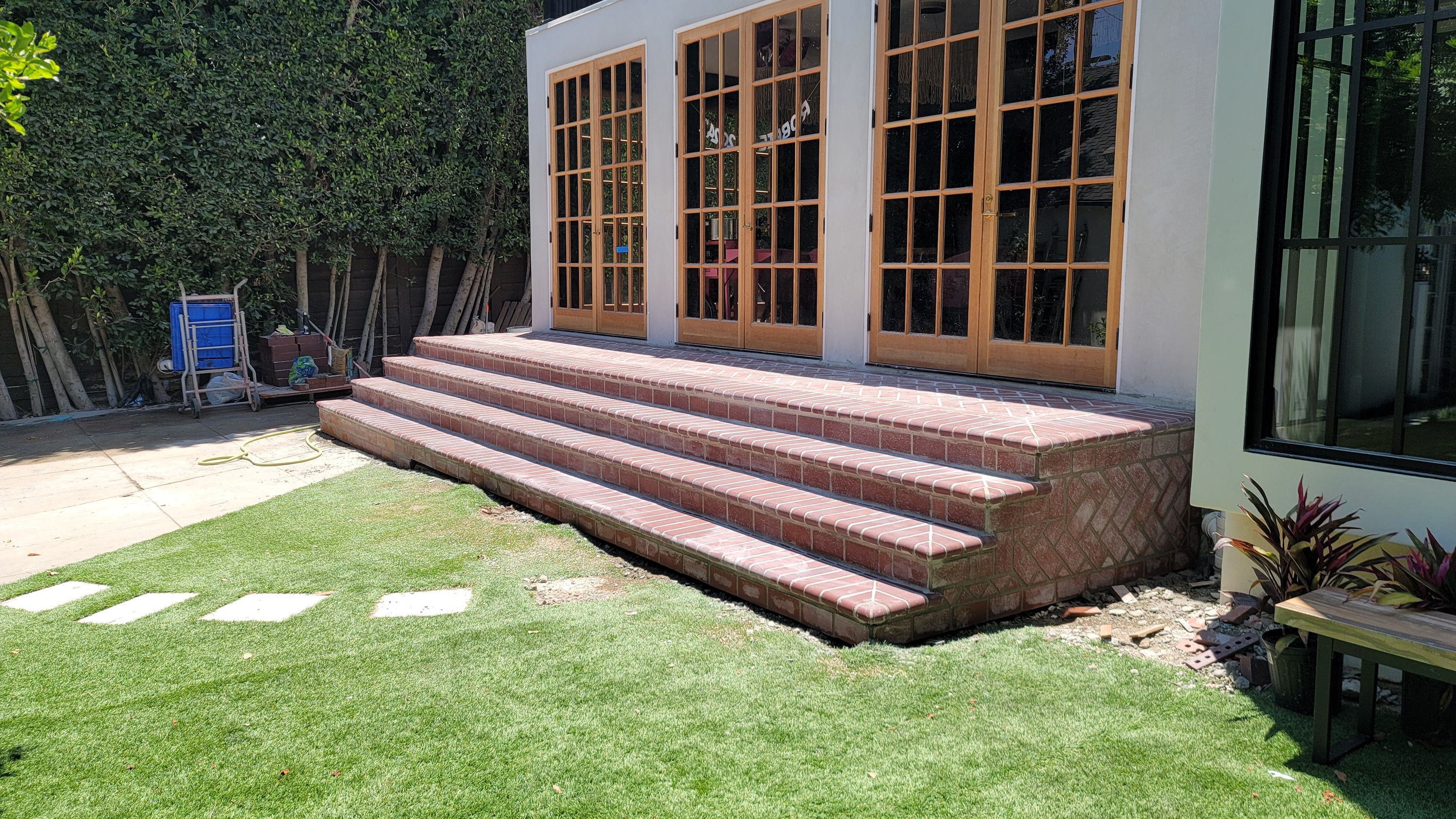 Brick steps and landing in front of a window wall