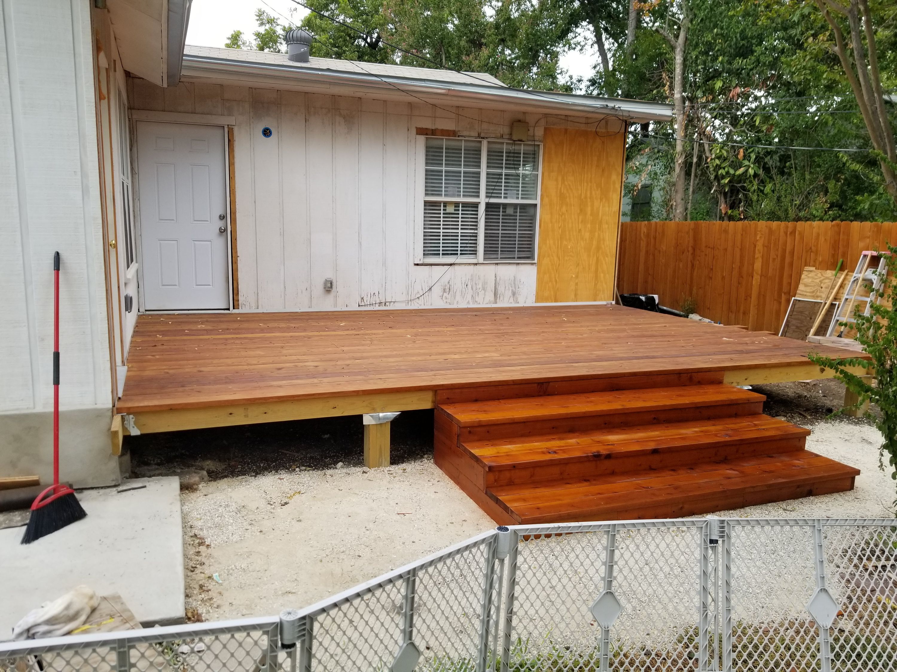 Redwood deck platform and steps built against a house
