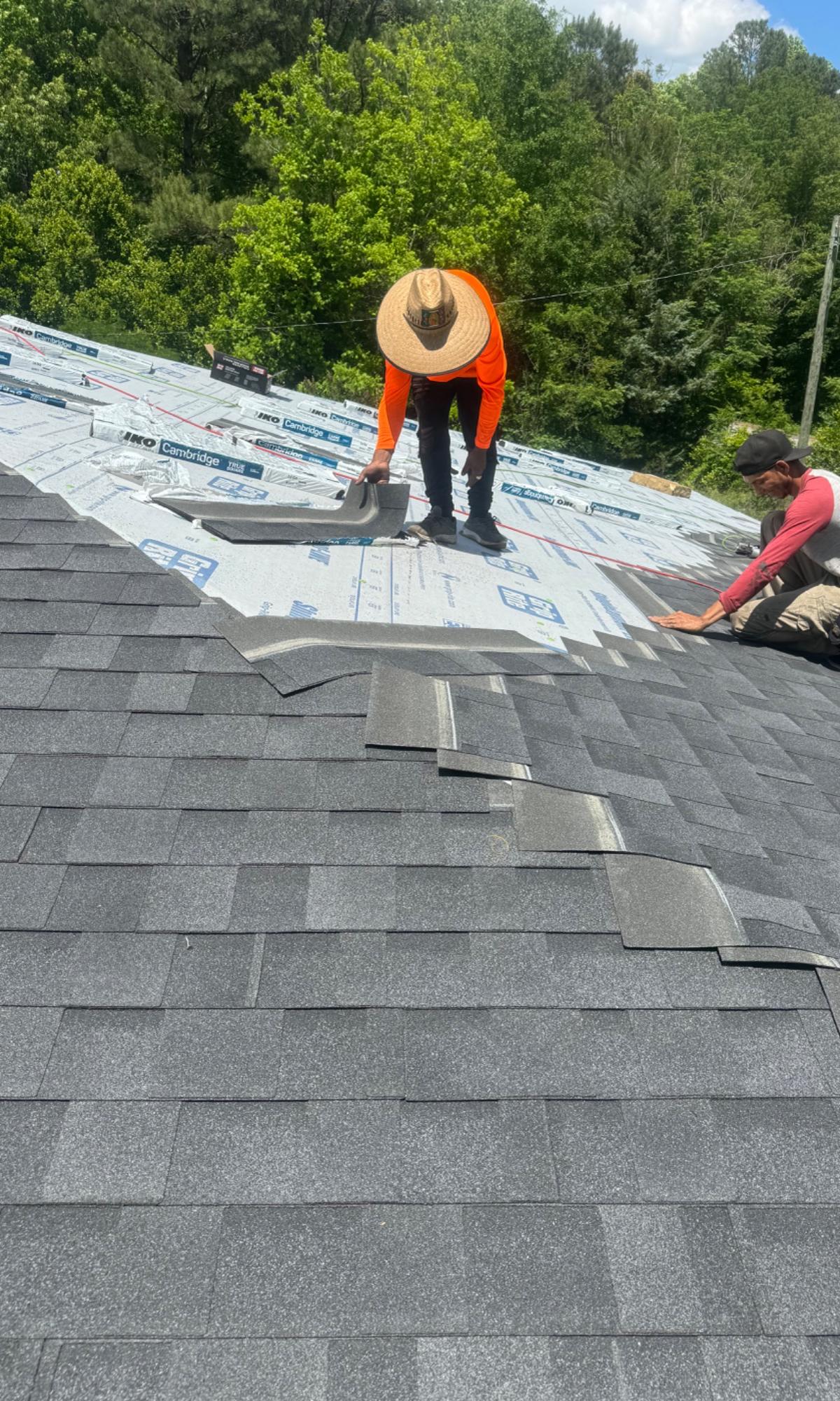 Hyperborean Contracting crew installing new architectural shingles