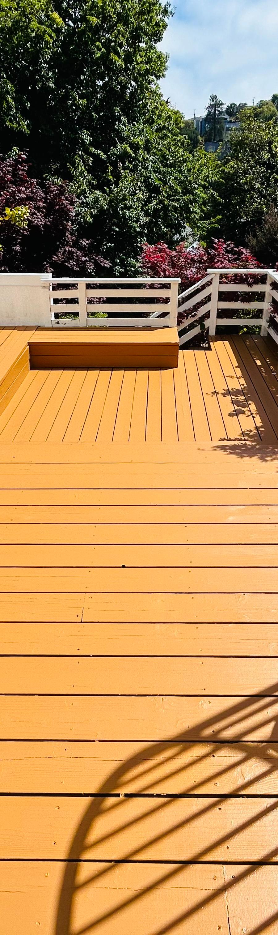 Finished deck with white railings overlooking the Bay Area hills