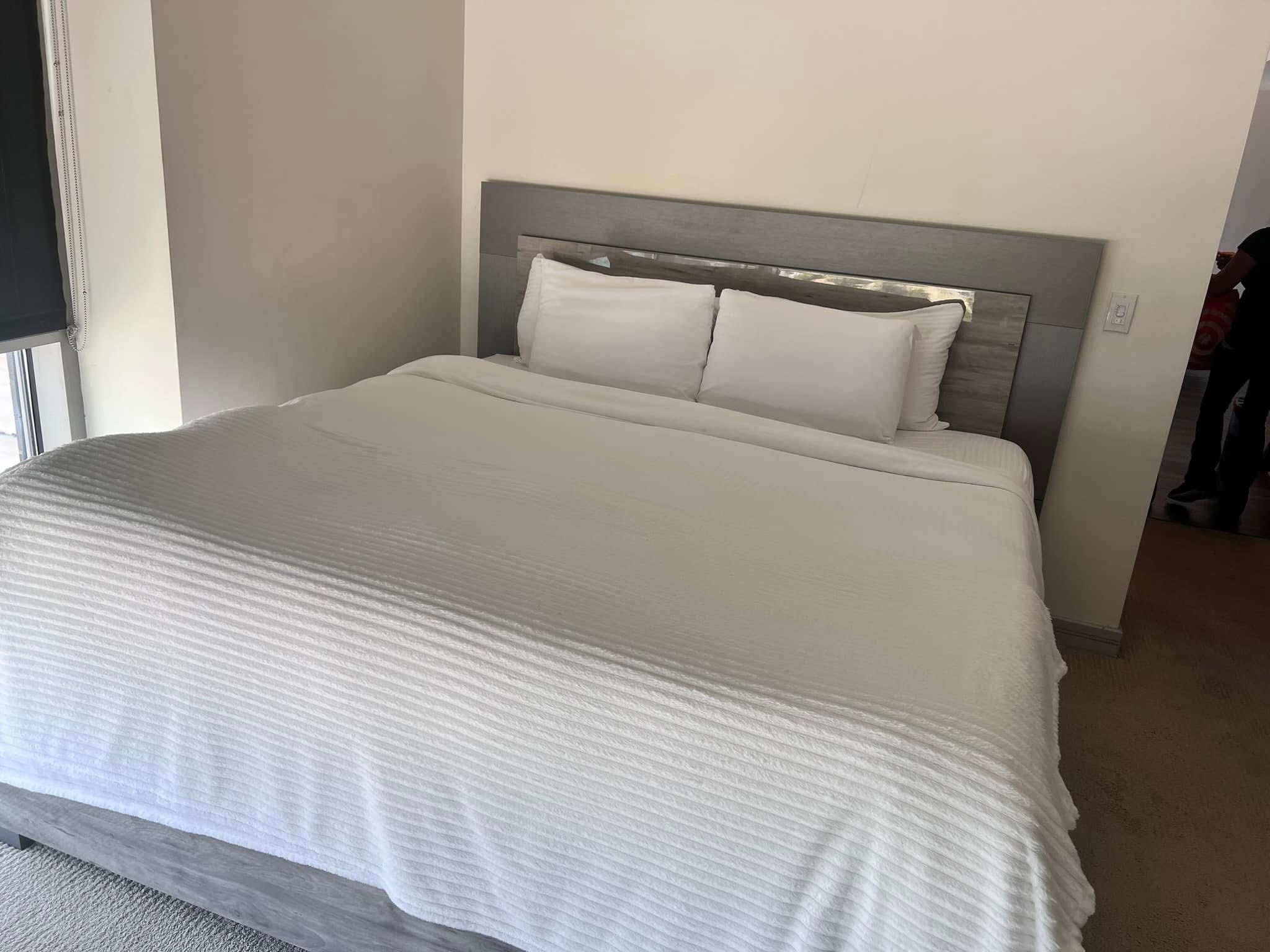 Guest bedroom reset with crisp white bedding and clean surfaces