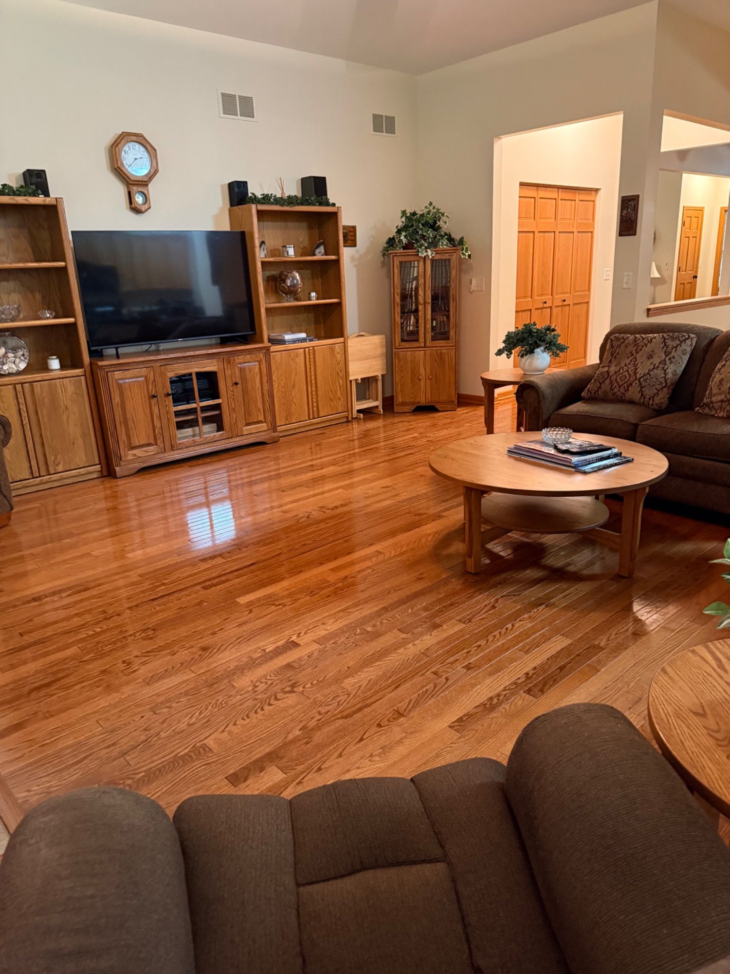 Clean open living room with polished hardwood flooring